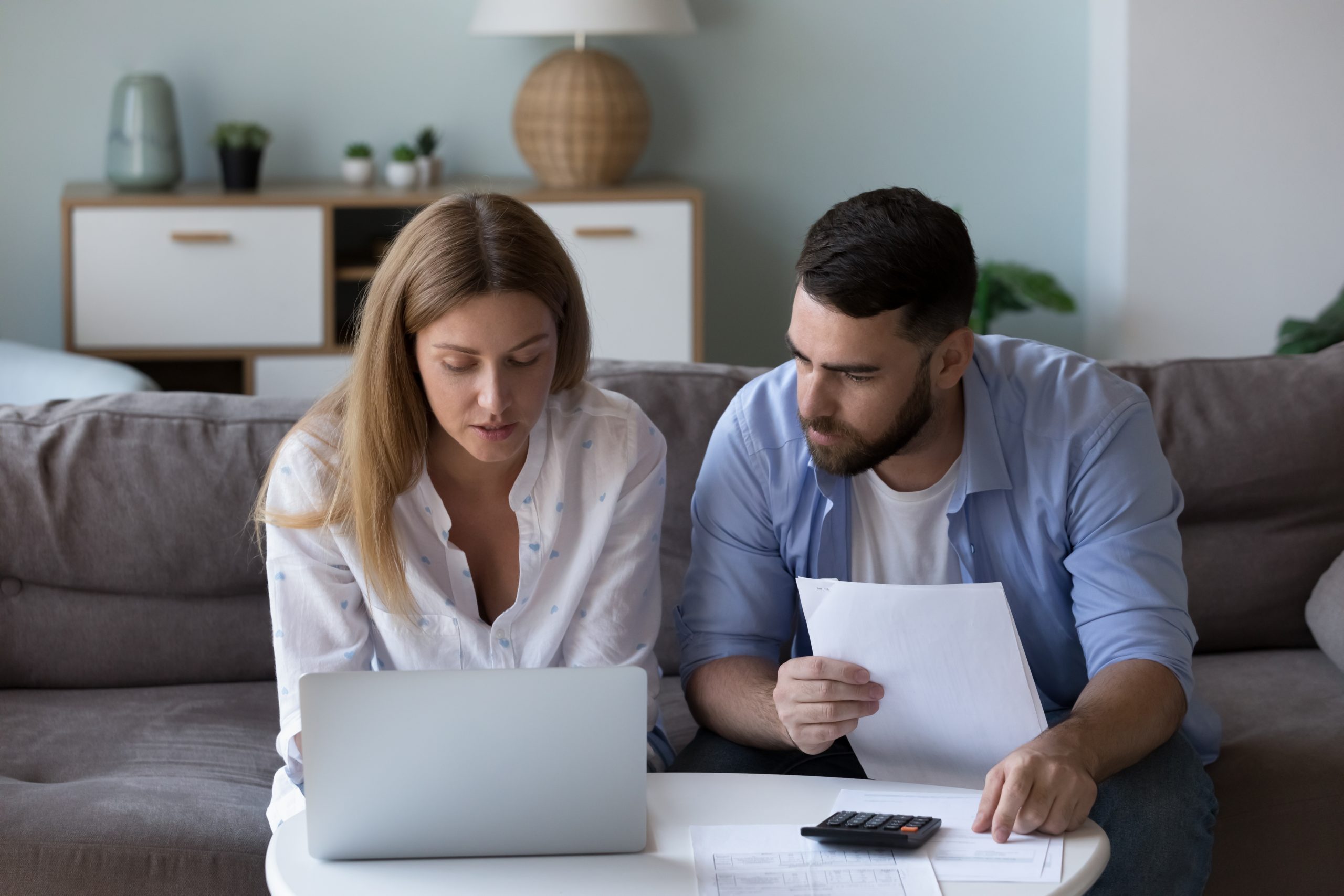seriously focused couple analyzing checking accounts