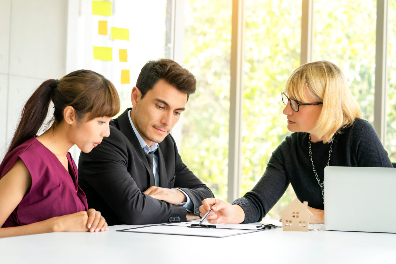 banker explaining questions to ask to choose a checking account