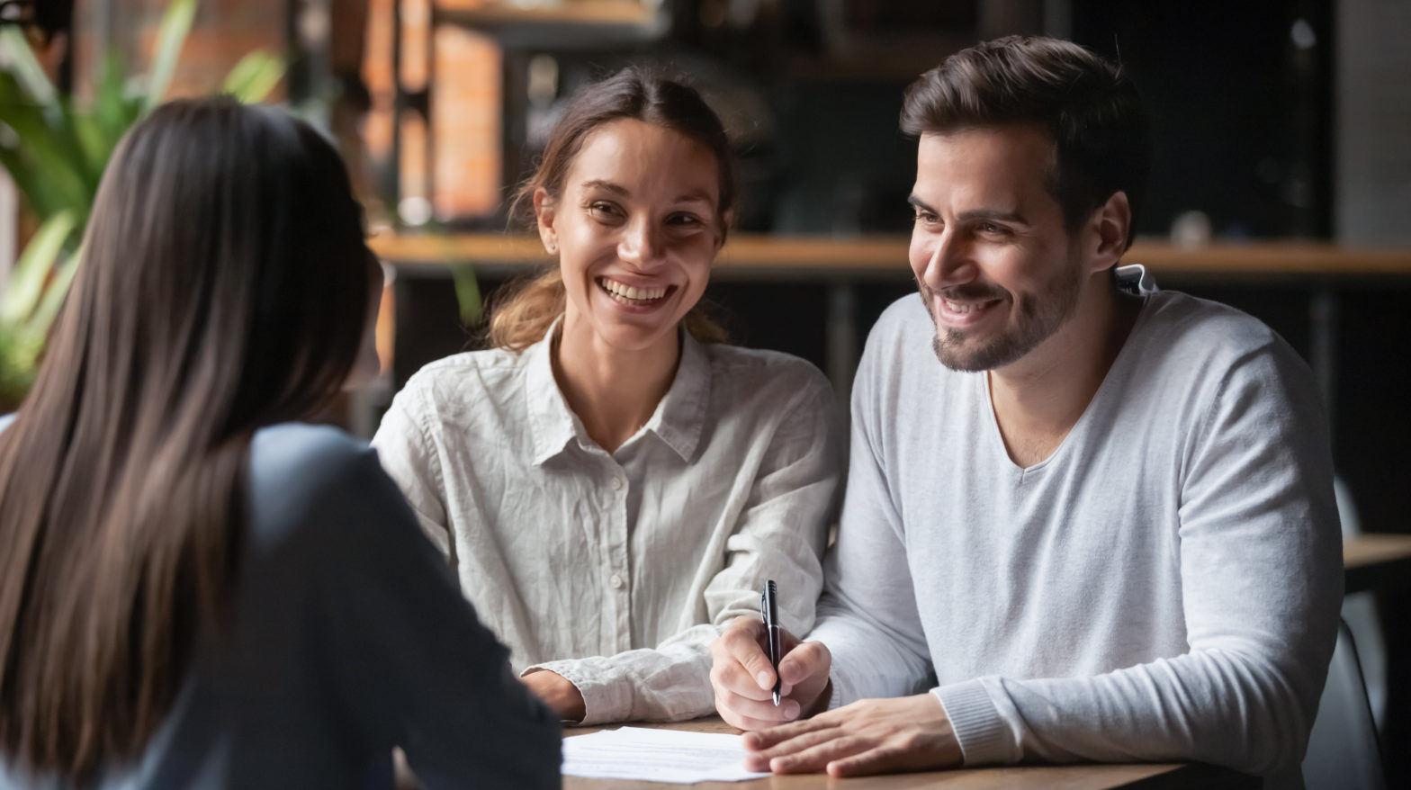 couple ready to sign joint checking account at bank