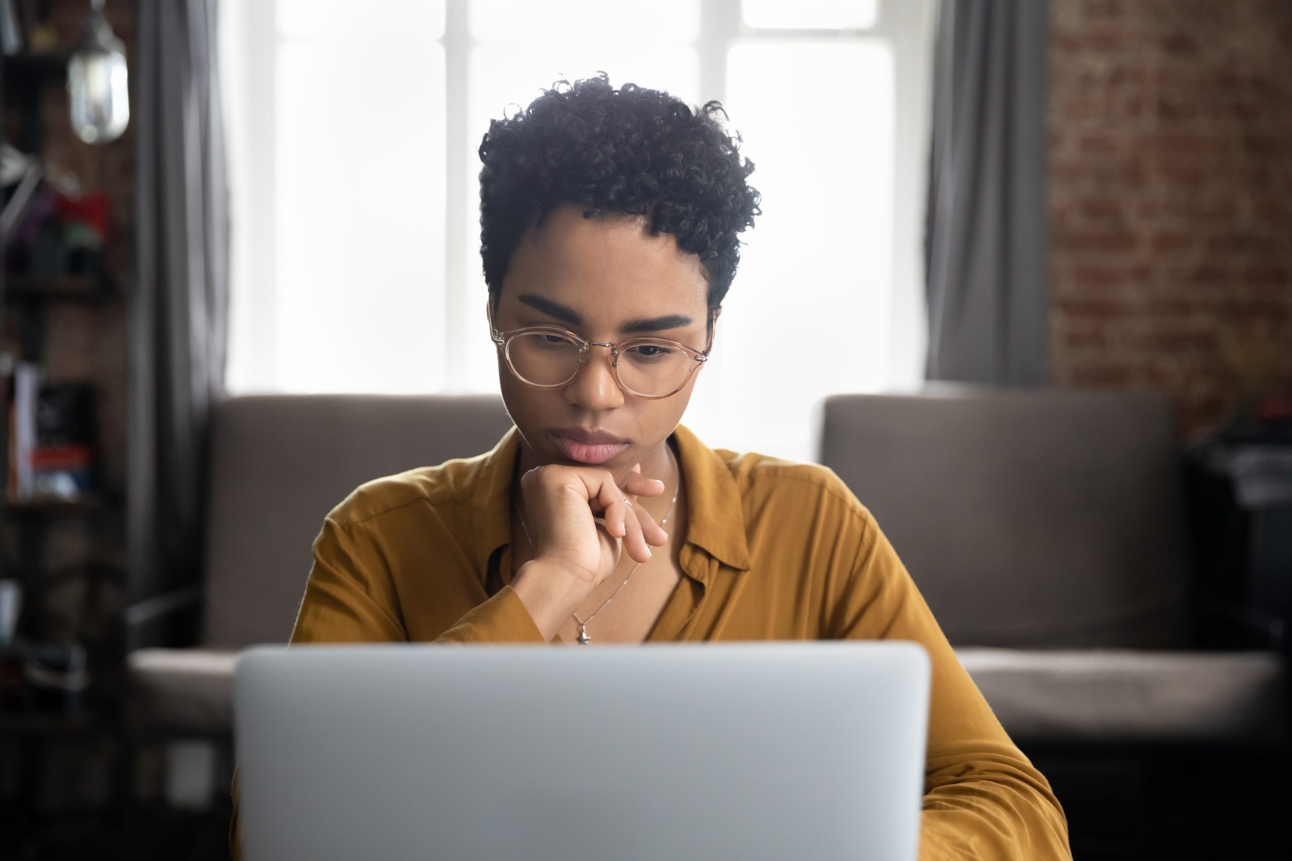 Women staring at laptop to understand restrictions to find best money market accounts
