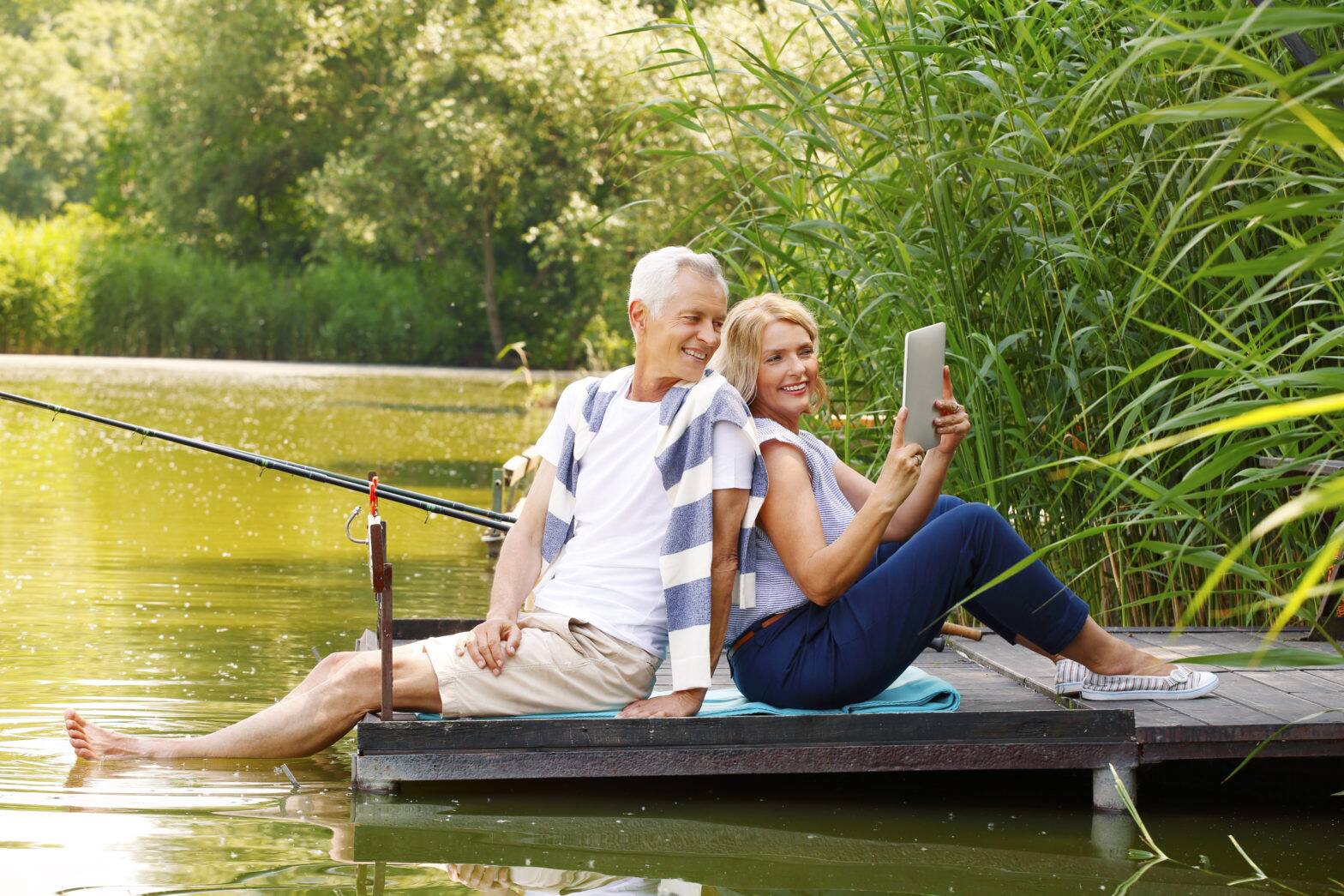 elderly couple relaxing at nature