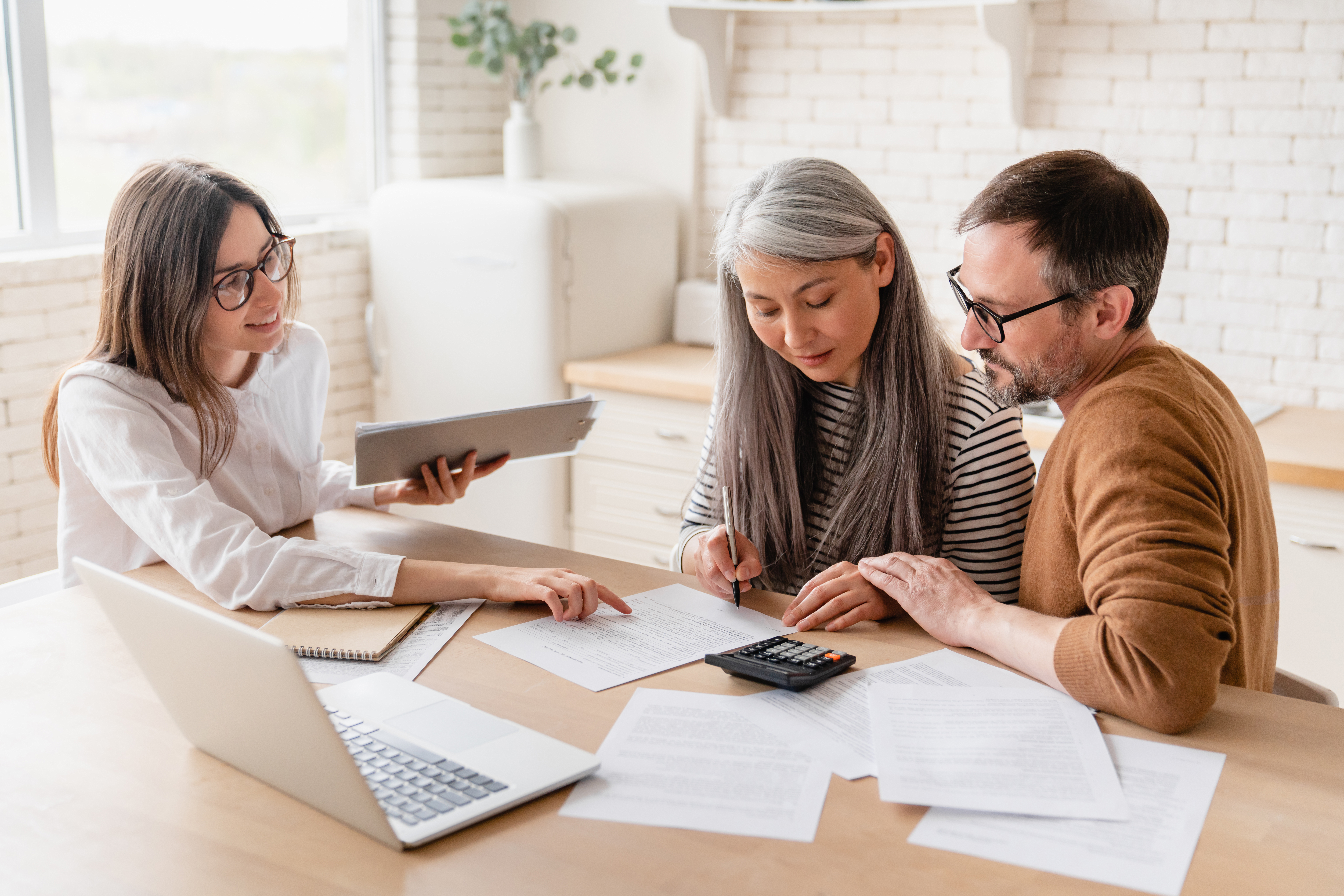 insurance agent consulting mature family couple discussing health insurance