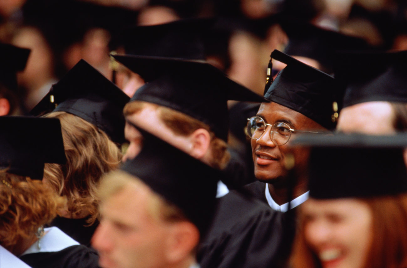 College graduates are seated during the ceremony