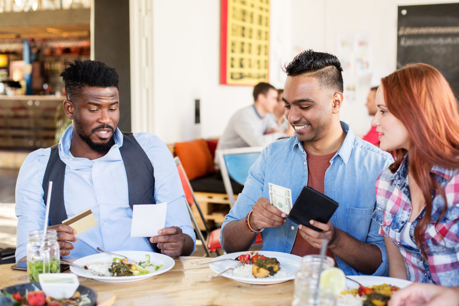 Men forget to have cash and friend is paying the bill from their wallet having cash