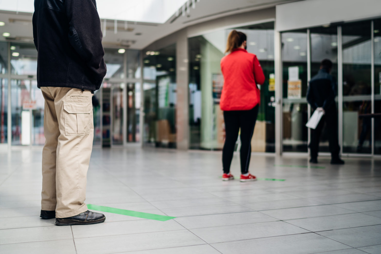 people standing in line front of bank