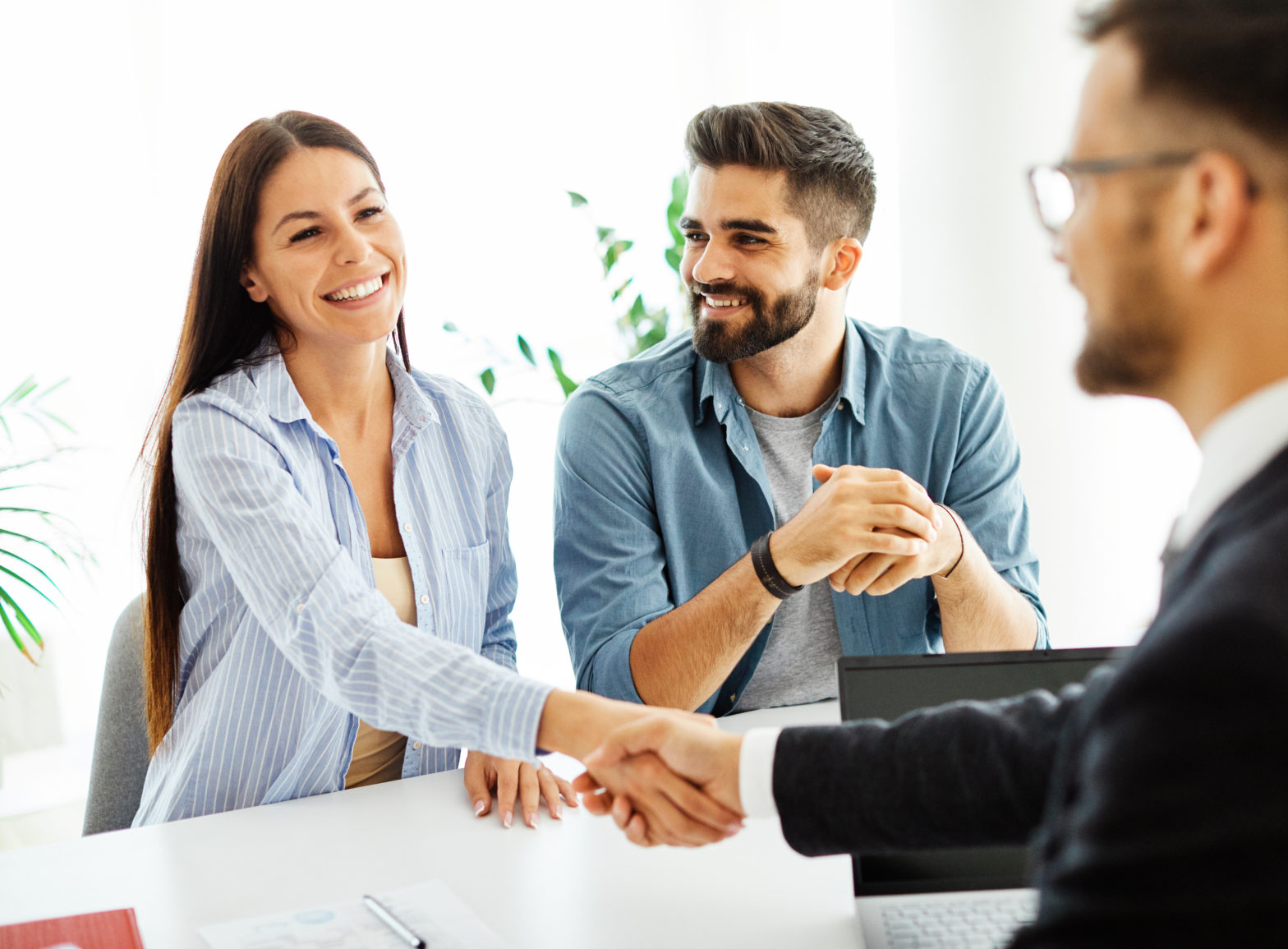 millennials shaking hands closing a deal