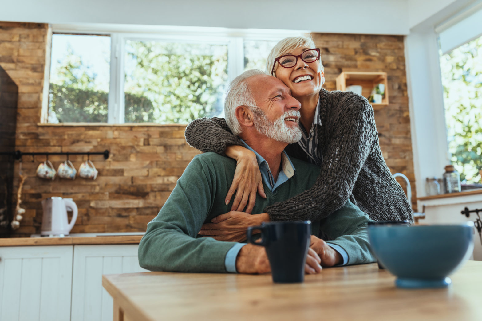 old woman hugging her husband