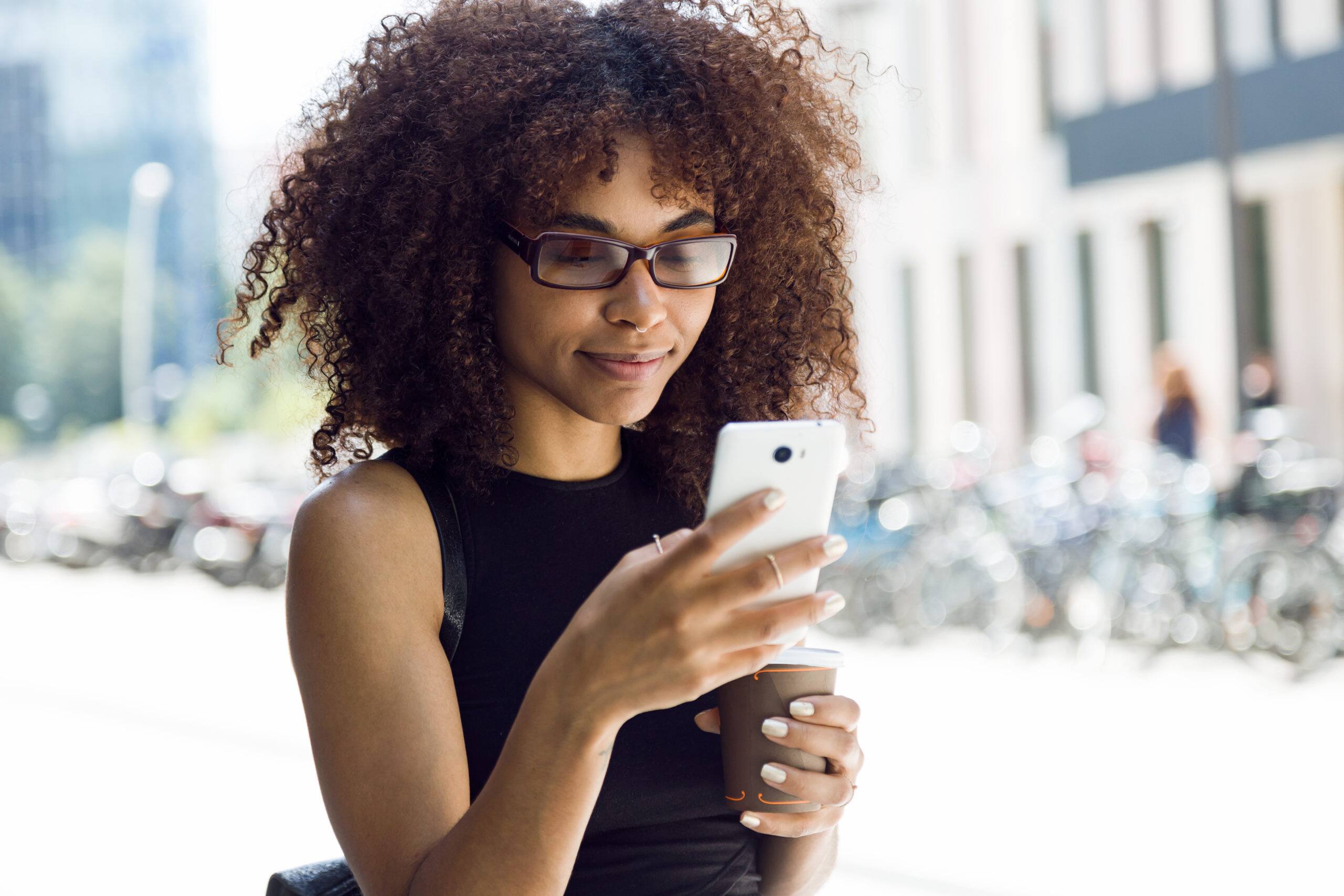 Young woman using her mobile phone to read about savings and finances