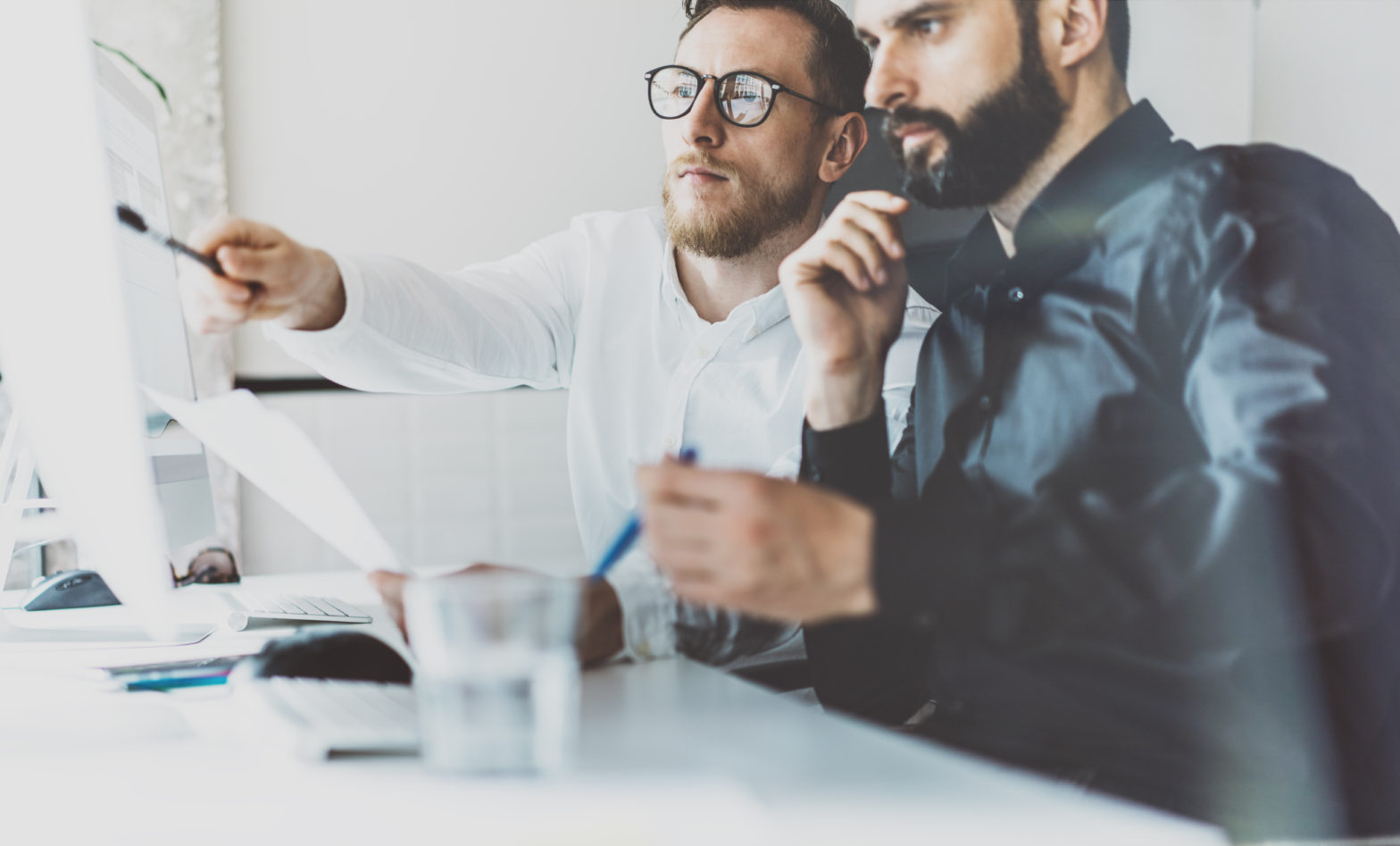 two men discussing investment risk on computer screen
