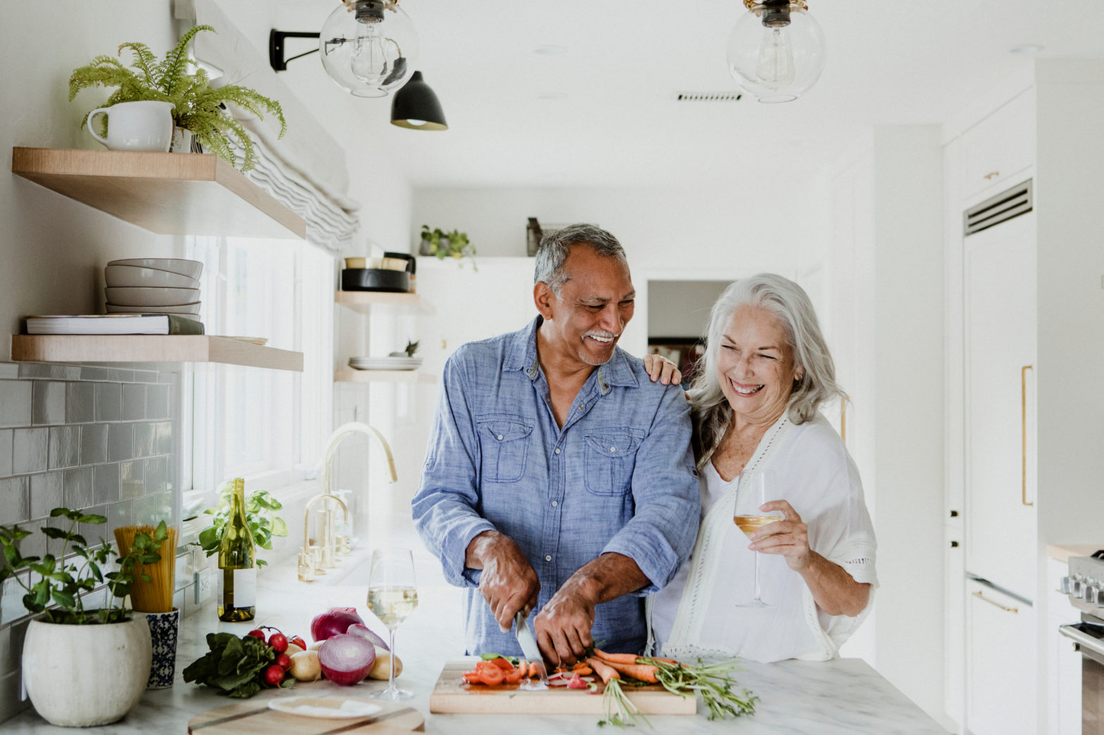 elderly couple cooking in a kitchen