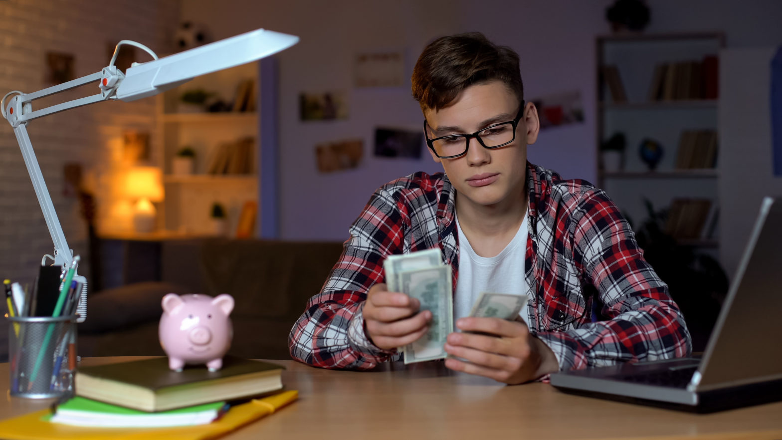 college student counting dollar bills