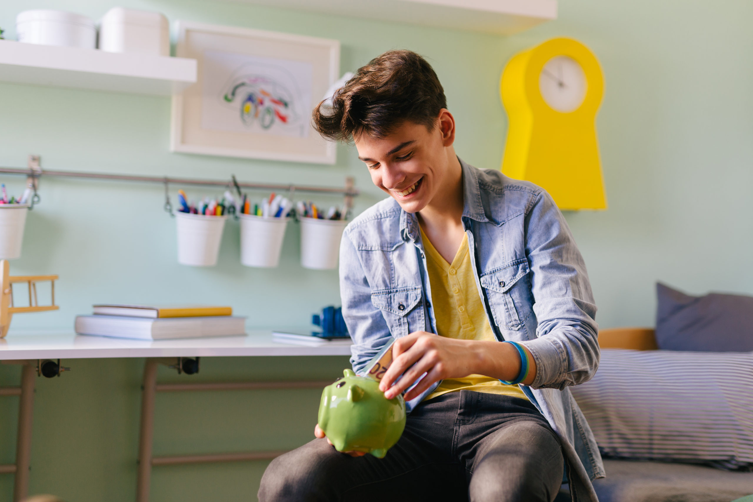 teenage boy saving money for university