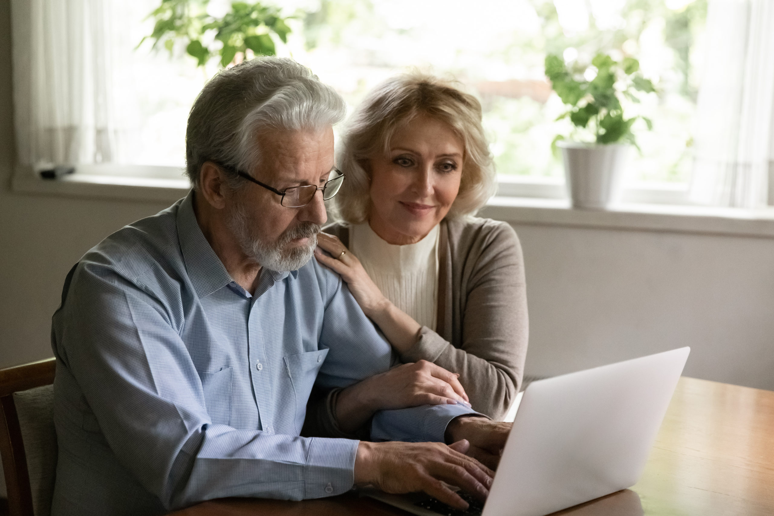 couple using the laptop and working on 401k