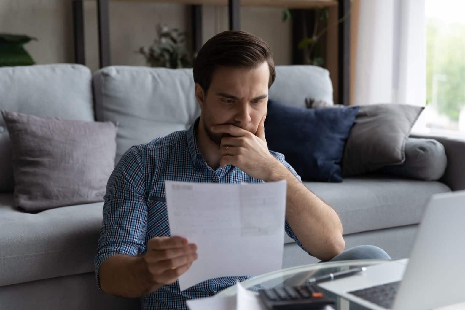 man checking financial documents affecting savings and money market rates