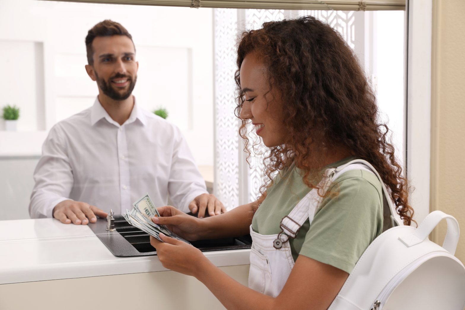 woman with money at cash department window