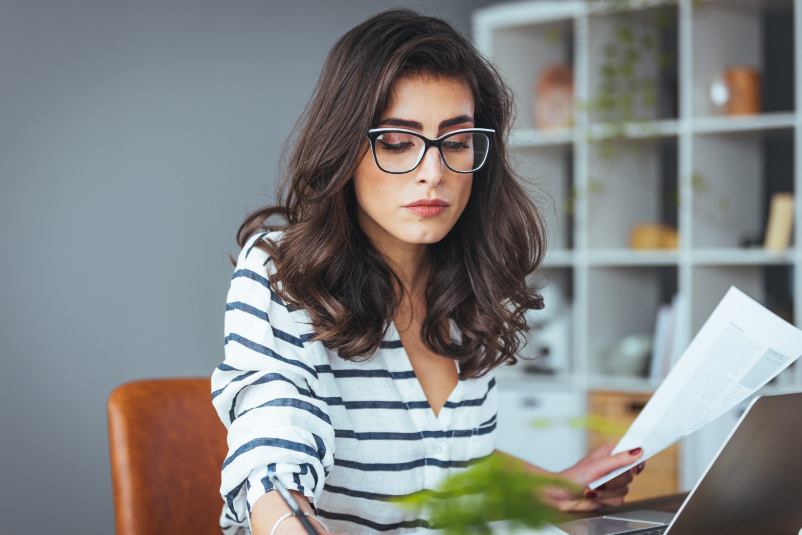 woman holding and looking at saving account book