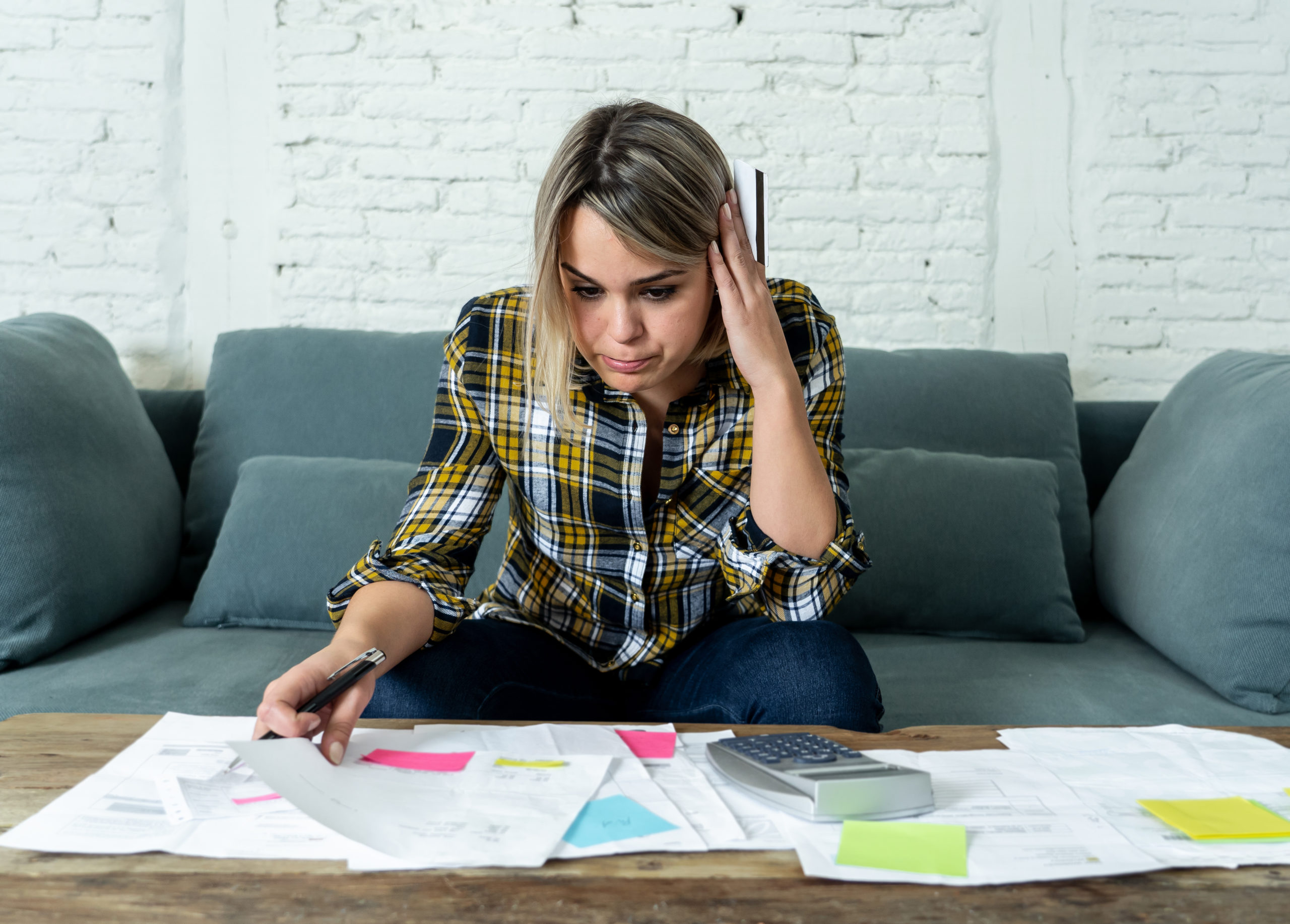 woman checking bills and calculating debt situation