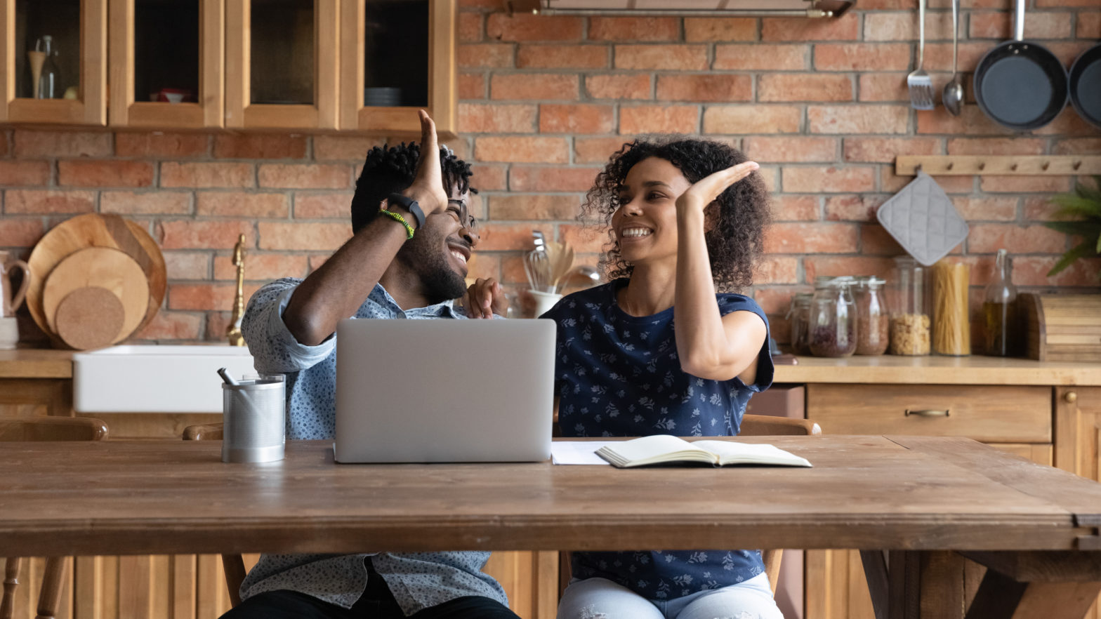 happy successful couple celebrating financial achieve at laptop