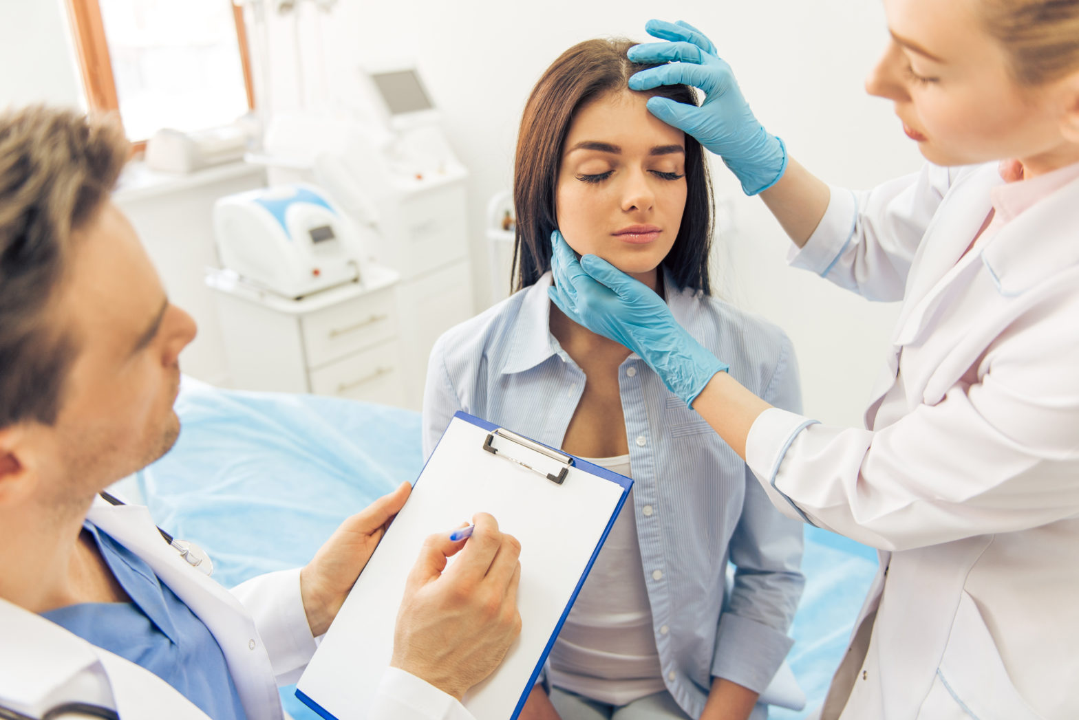 young woman is sitting and doctors discussing plastic surgery