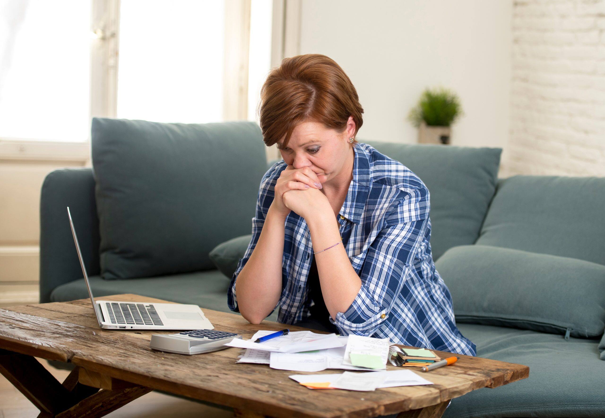 women worried about bills and calculating excess credit expense