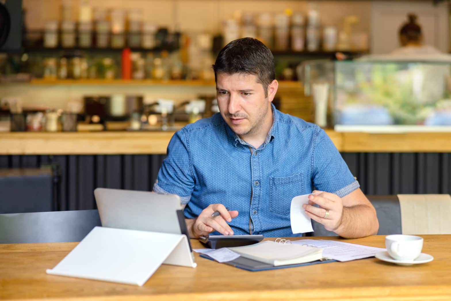 restaurant owner calculating tax bill of new business