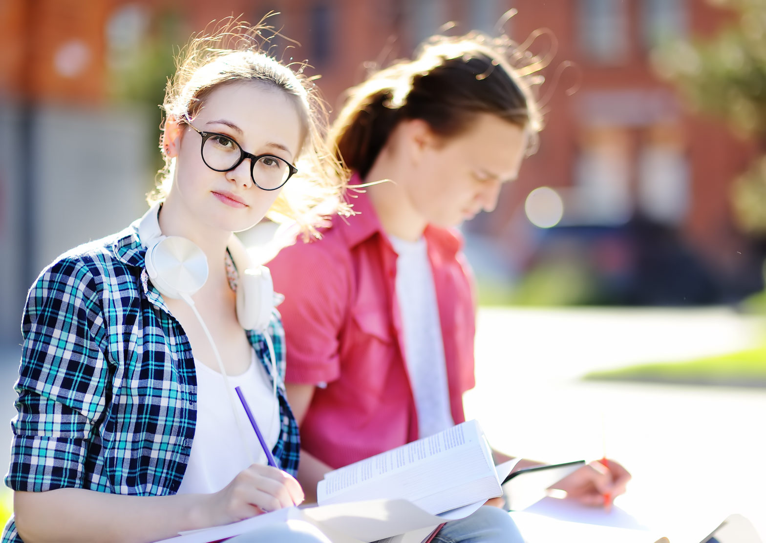 young happy students with books and notes outdoors
