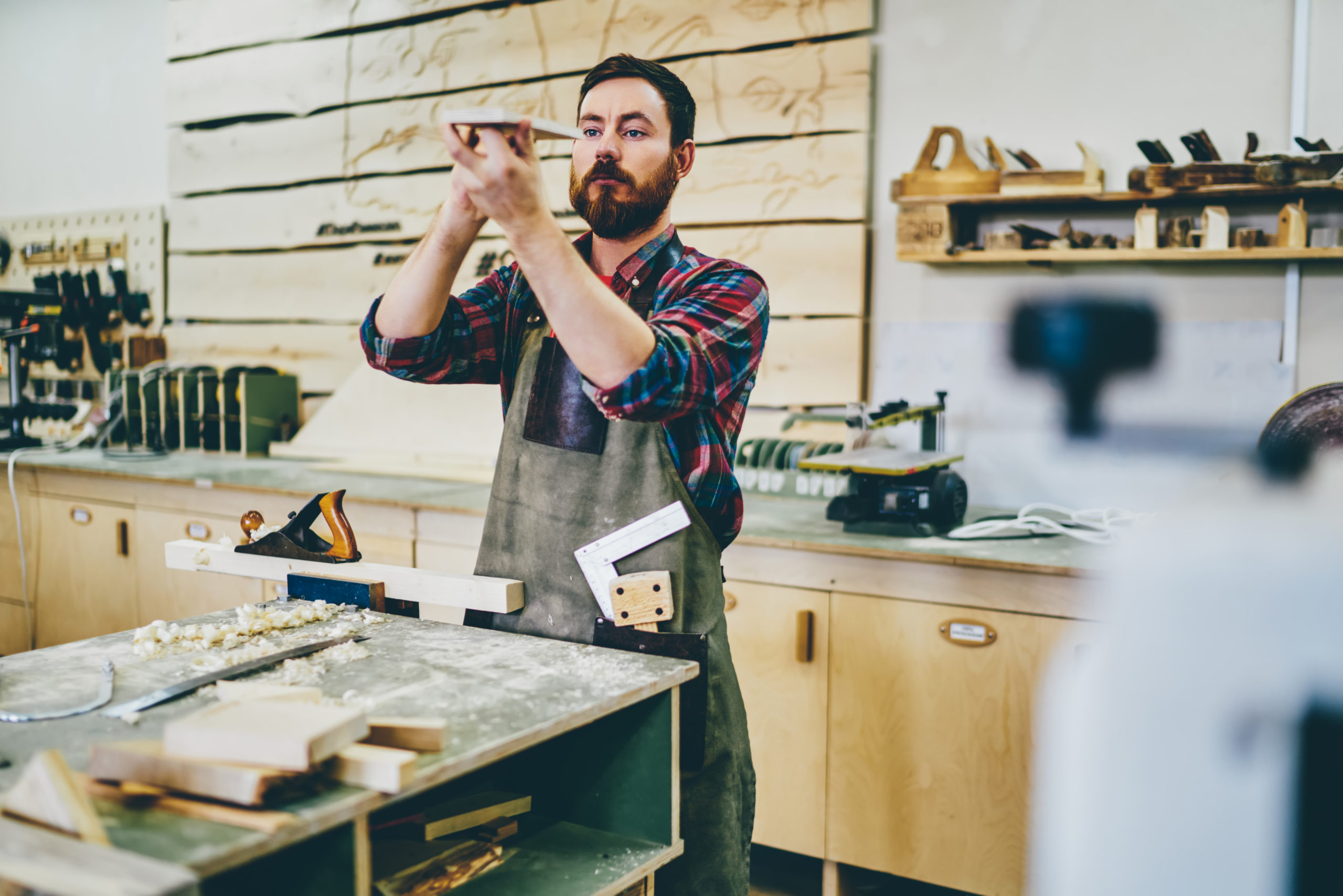 bearded carpenter enjoying hobby working process at his workstation