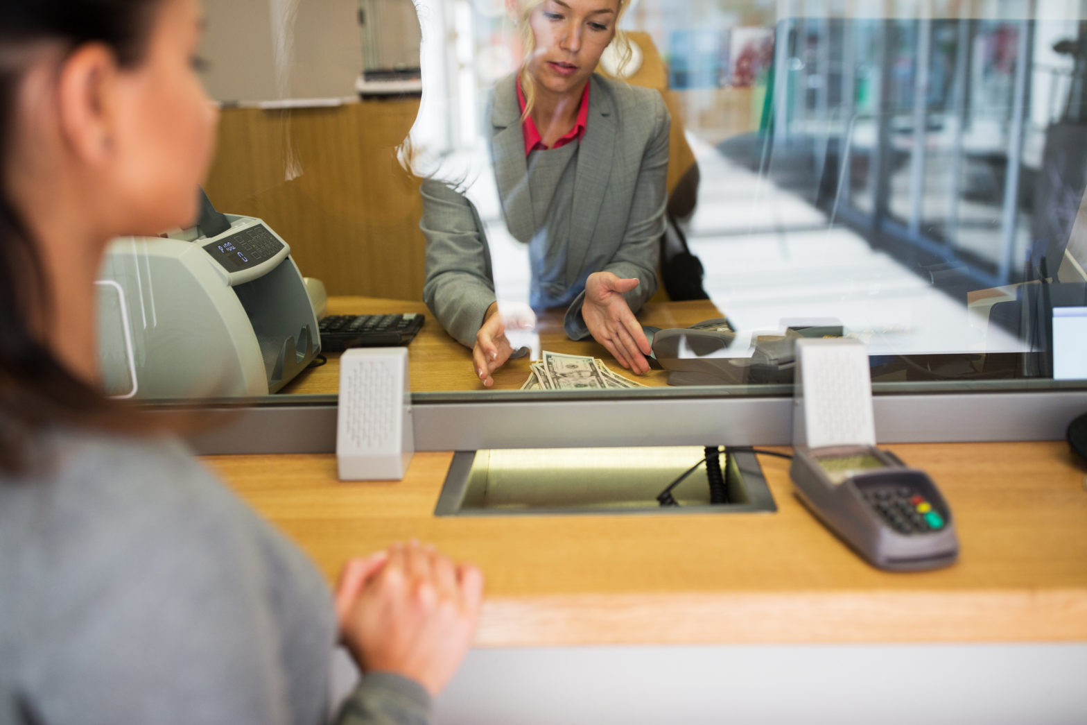 women at the withdrawal counter getting cash