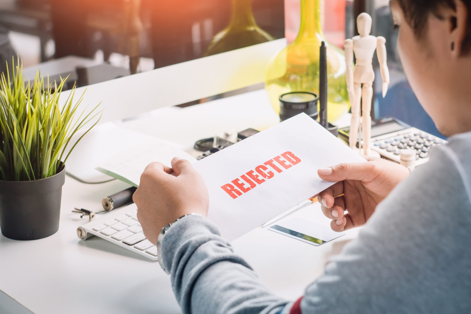 man holding rejected personal loan letter