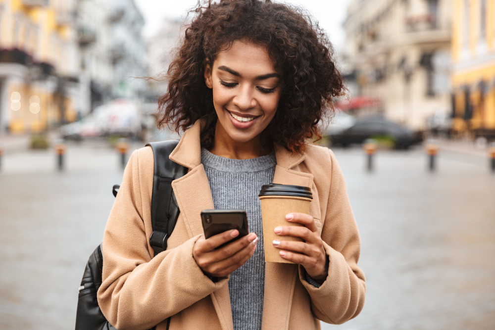 A woman uses her smart phone to shop for a loan