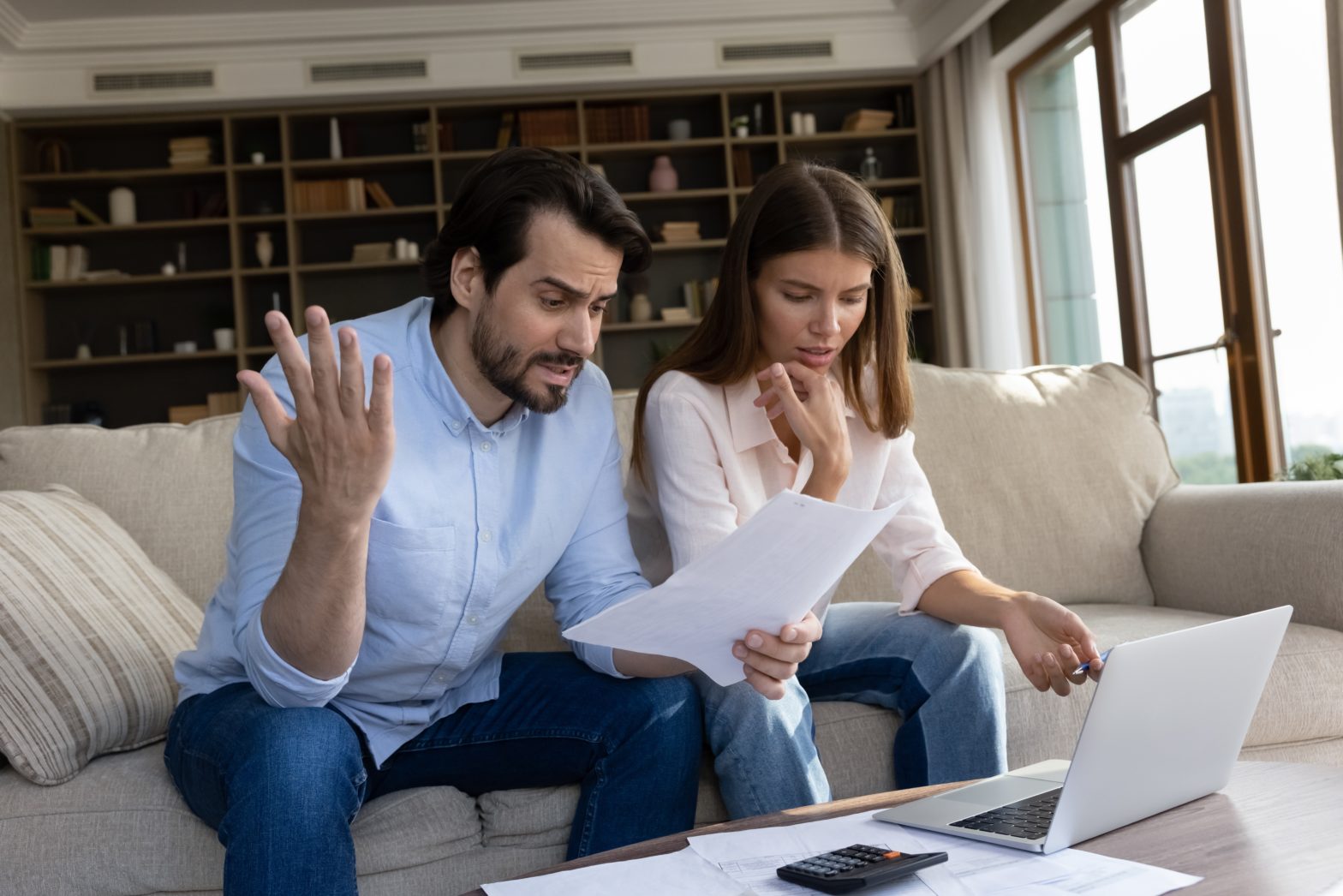 couple reviewing bills feels stressed having financial problem