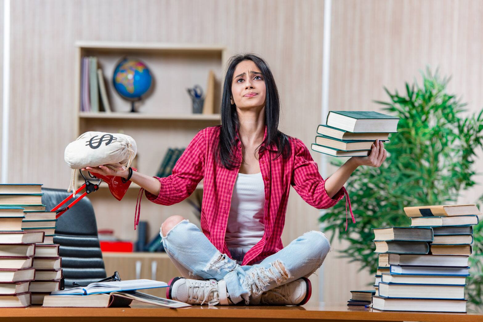 a young female student having books and student loan