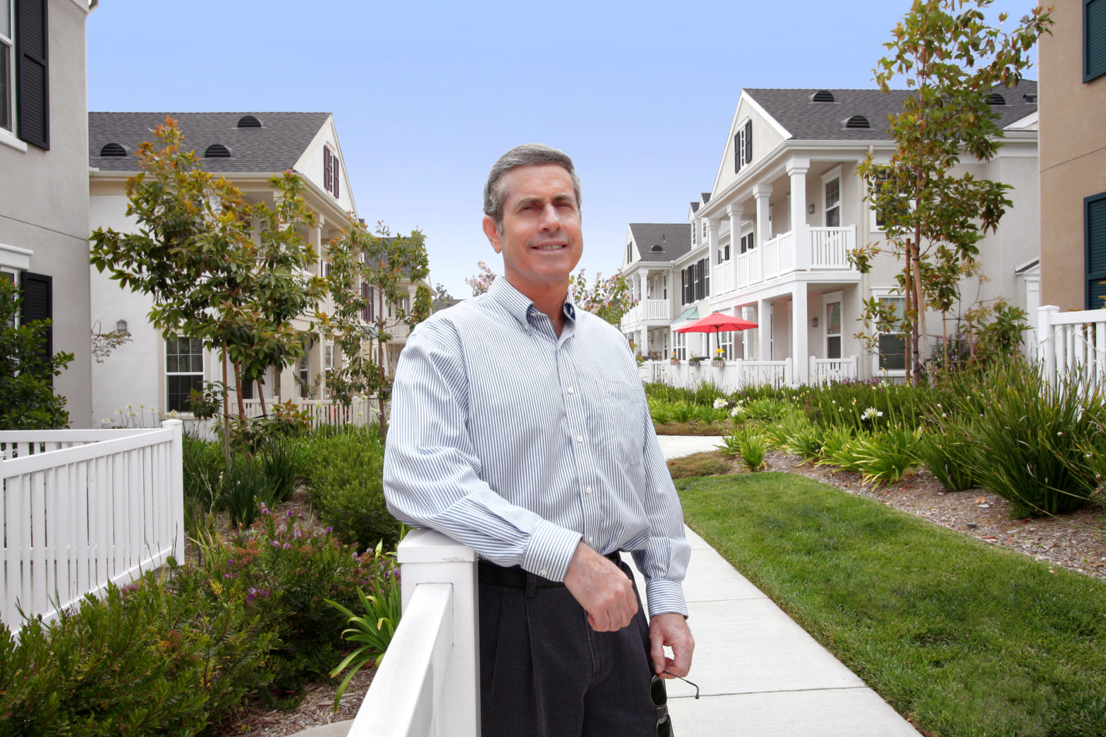 handsome older homeowner man and houses