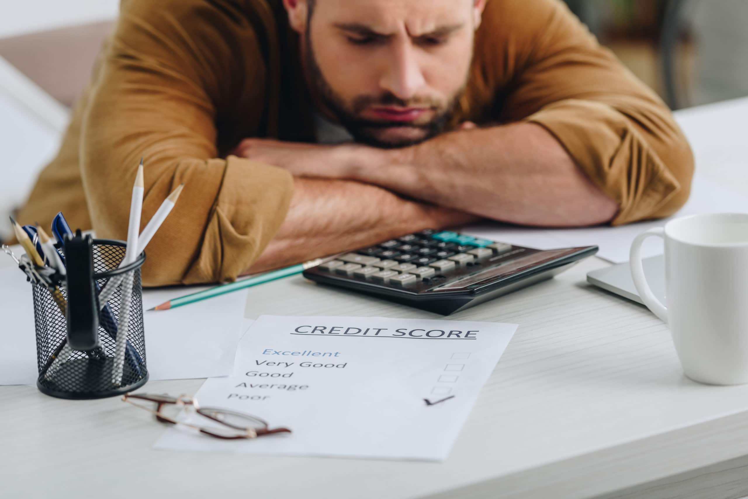 a sad man with closed eyes has credit score
