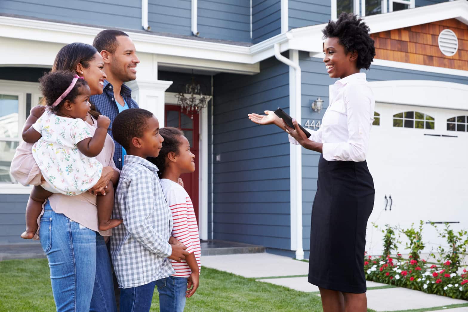 real estate agent showing a family a house