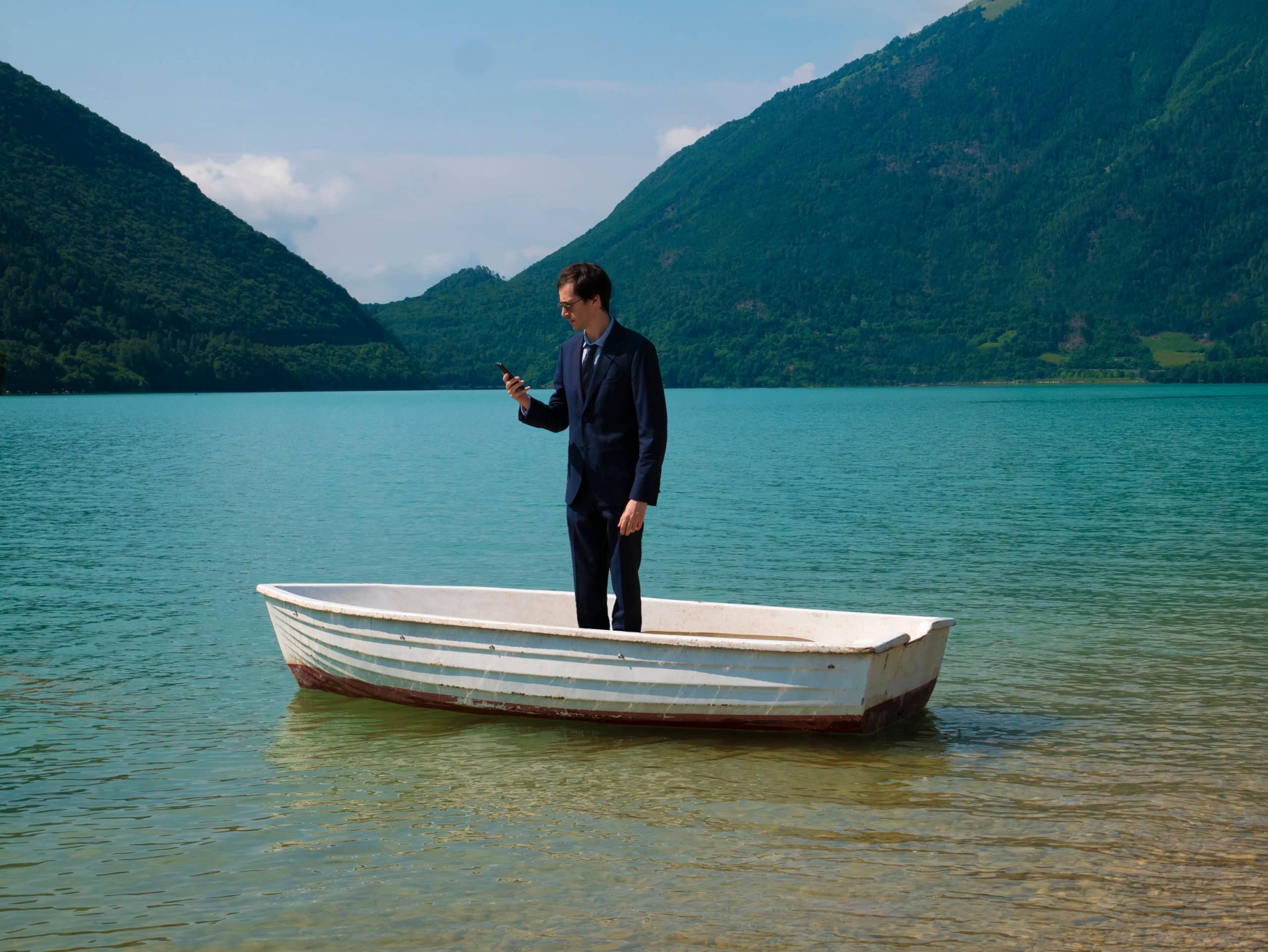 man standing in his own boat