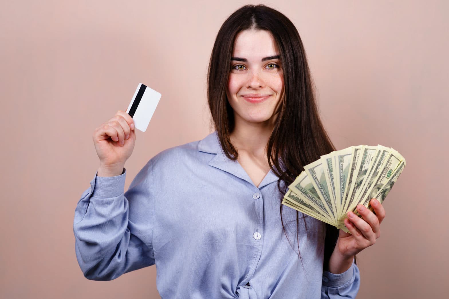 young happy cheerful woman with credit card and cash