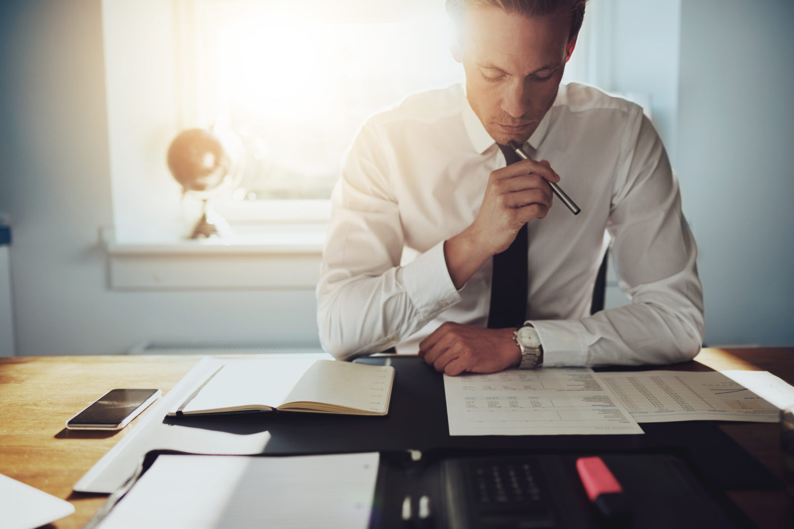 serious man working on the difference between saving vs investing