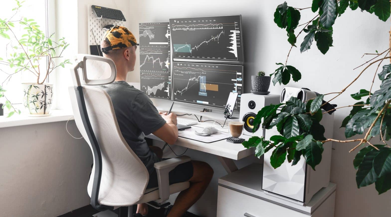 male trader in front of several monitors analyzes investment diversification