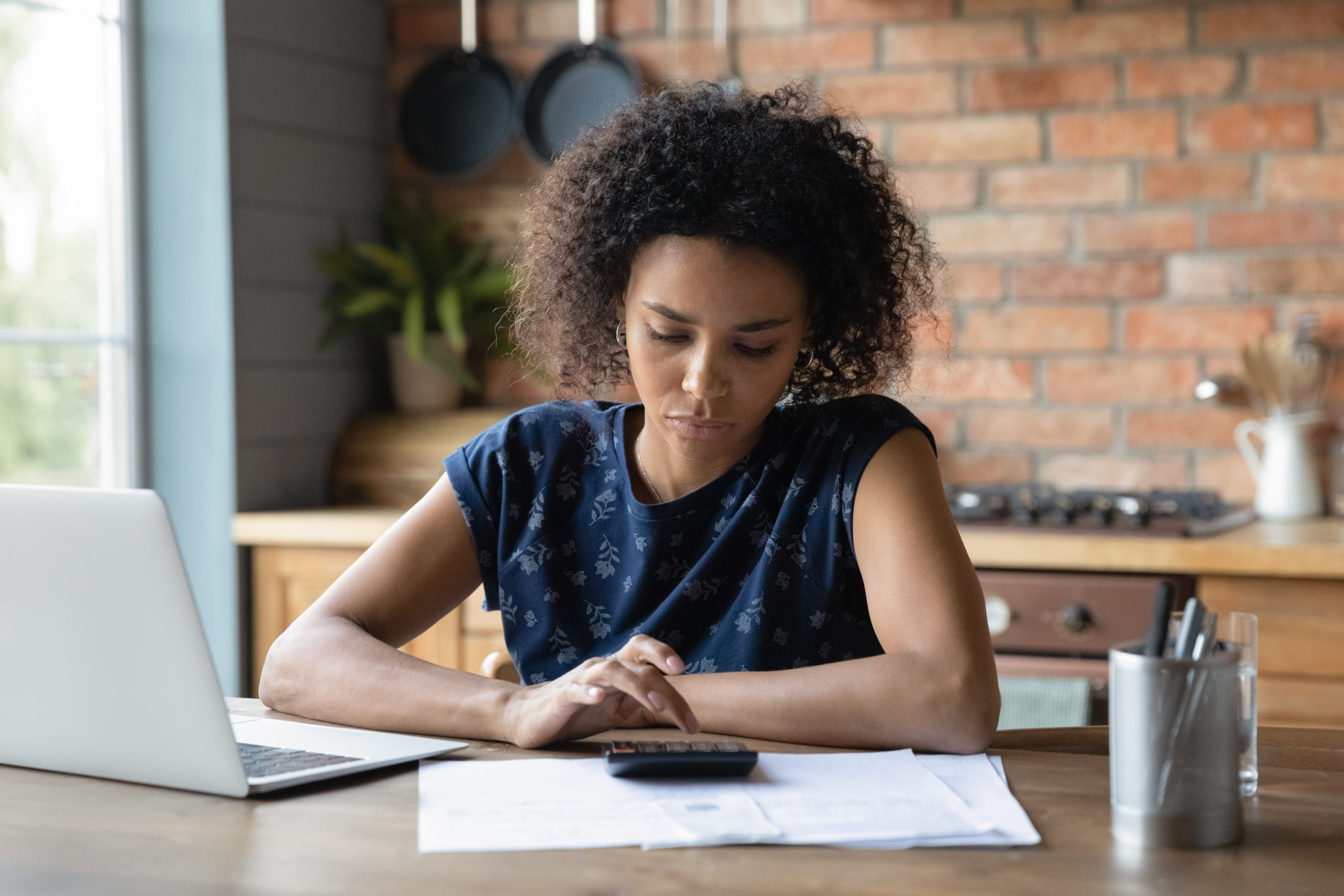women calculating tax implications of investing