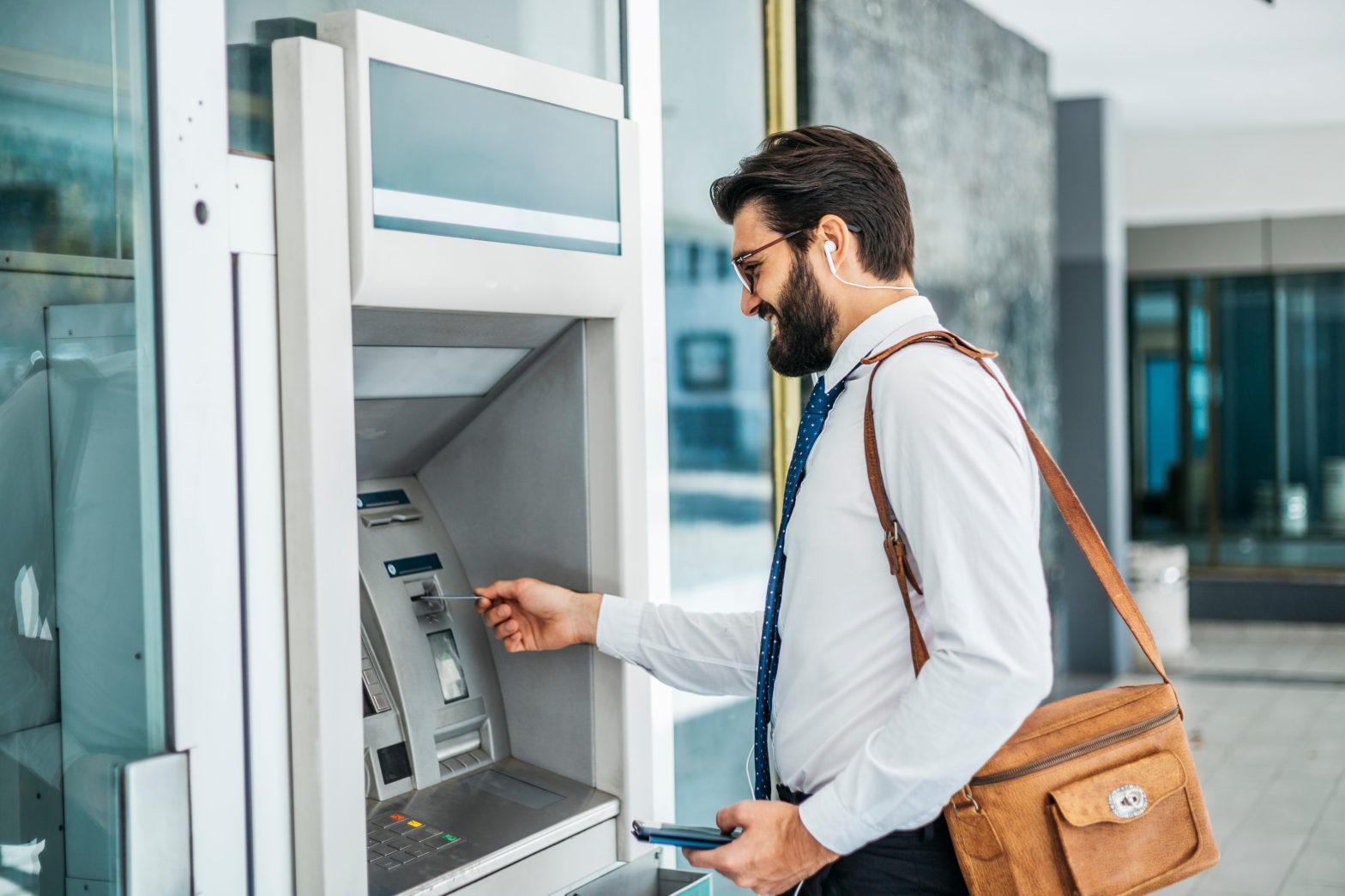 man using card at an atm