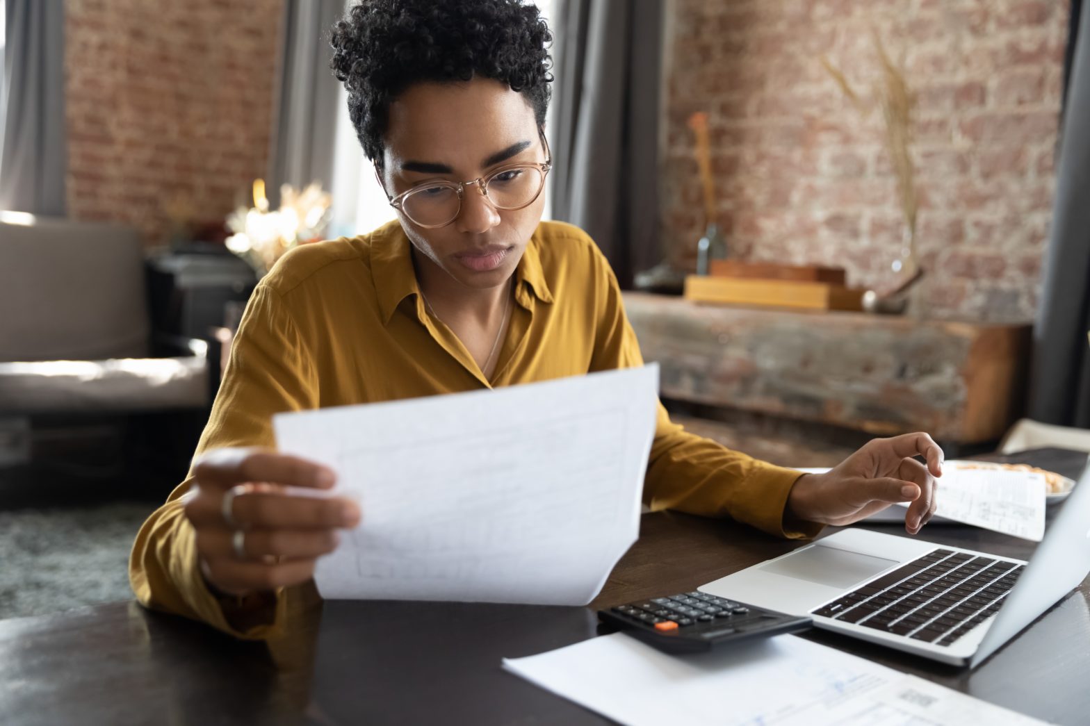 A young woman signs her tax return