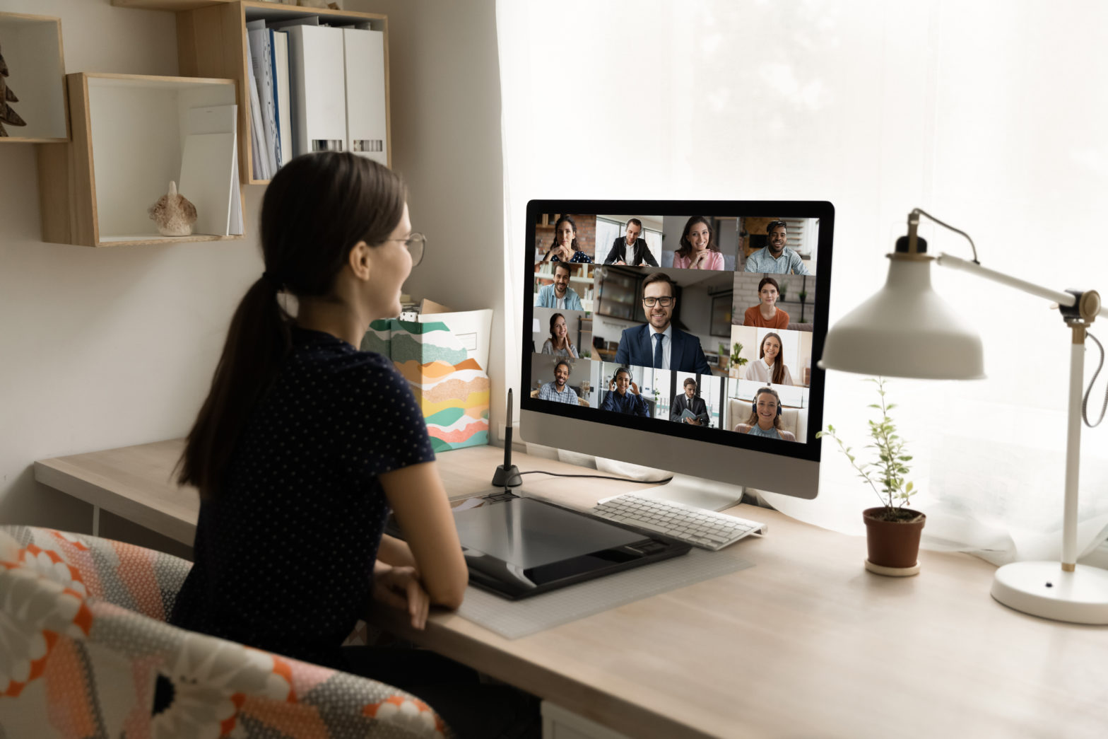 woman looking at computer and working remotely post-pandemic