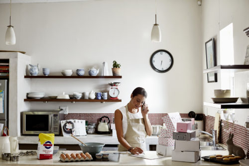 A small business owner takes orders over the phone