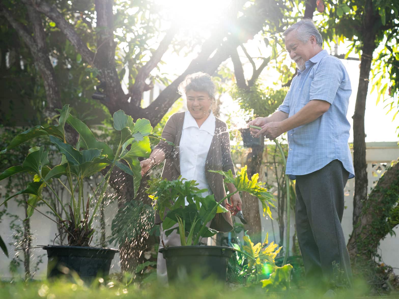 A retired couple spend time together tending to their garden