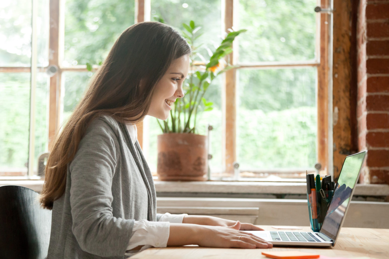 A college student is seen using her computer to work on a school project