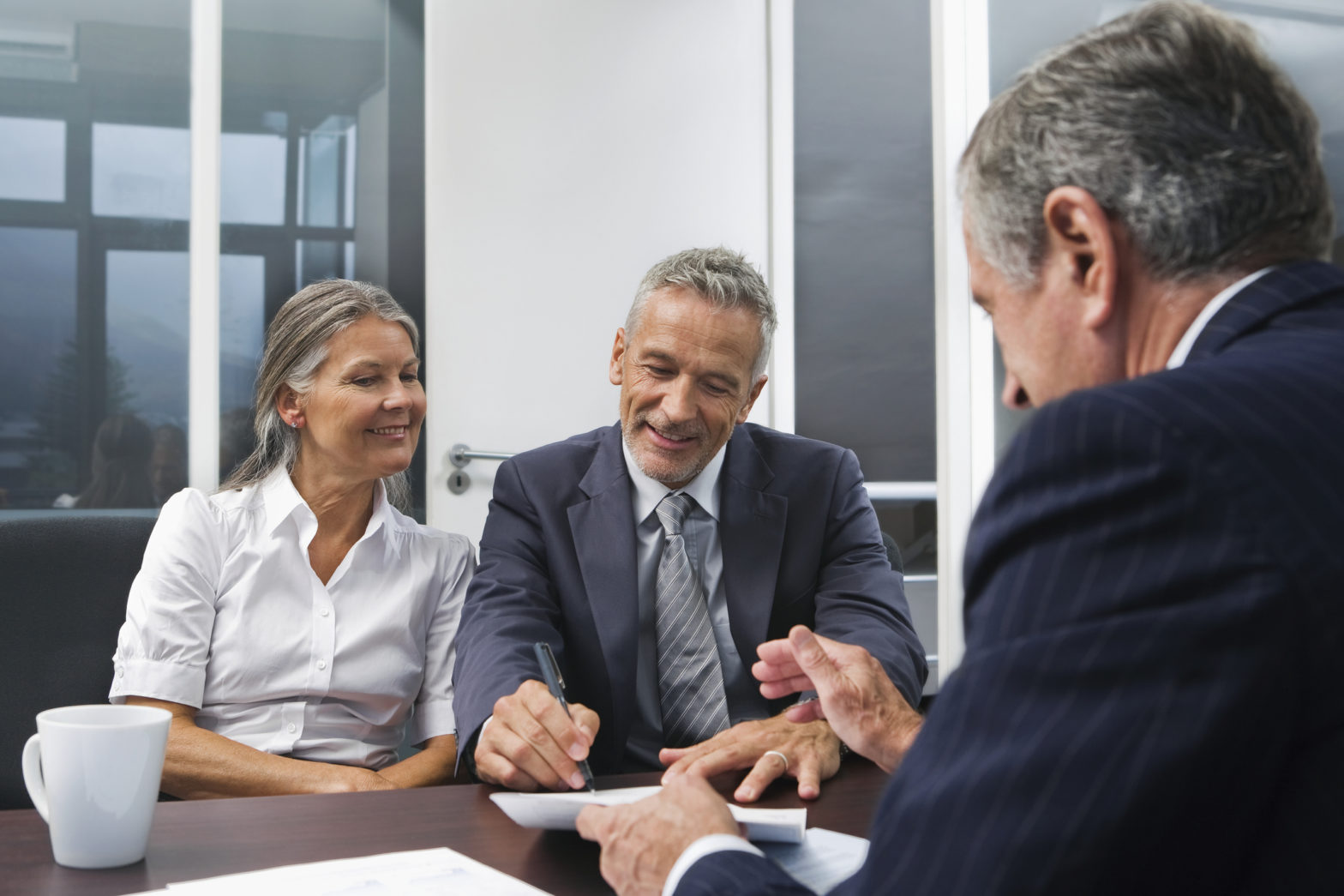 Middle aged couple talking to Financial Advisor