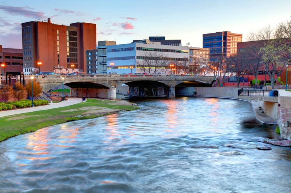 Sioux Falls, South Dakota skyline with river in foreground at dusk
