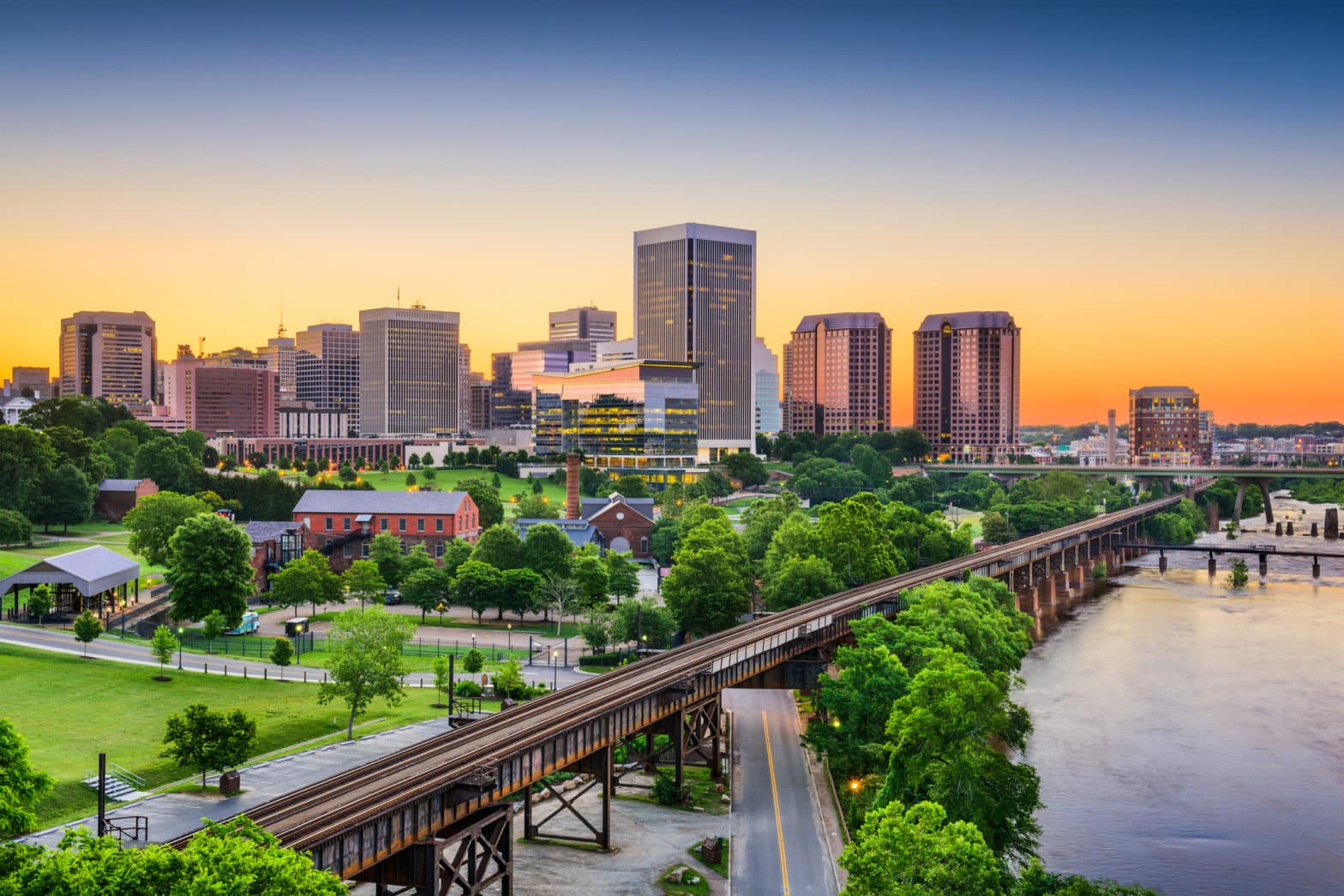 Downtown skyline of Richmond, Virginia with bridge and water.