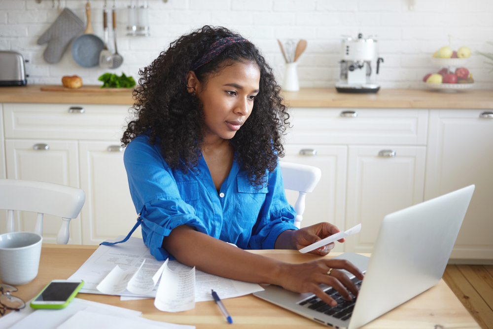 A woman uses her computer to manage her savings account online